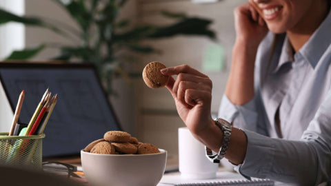 A women eating weleet millet cookies at office